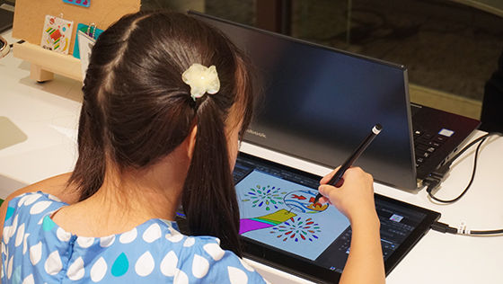 Participants painting in a coloring book