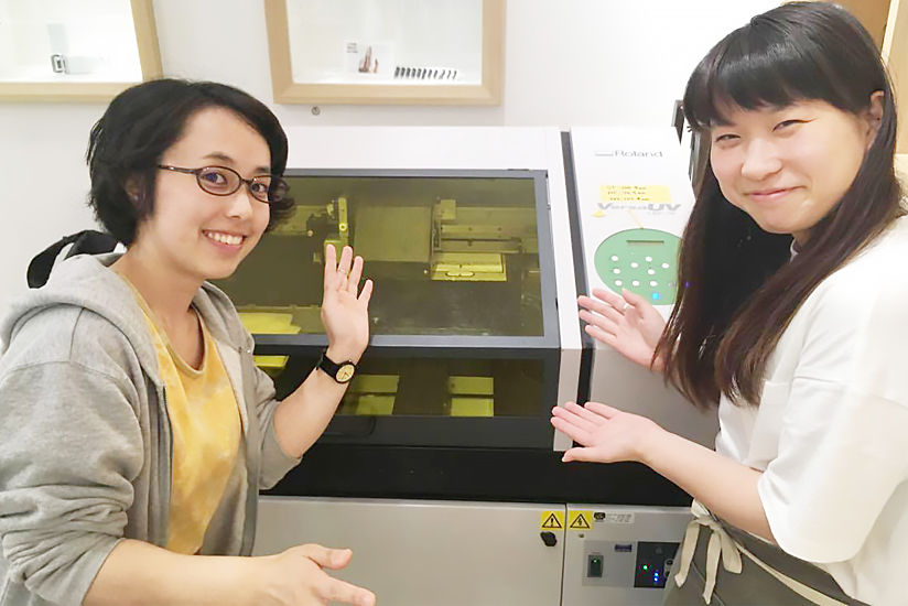 Roland DG's LEF-12 UV printer with event staff