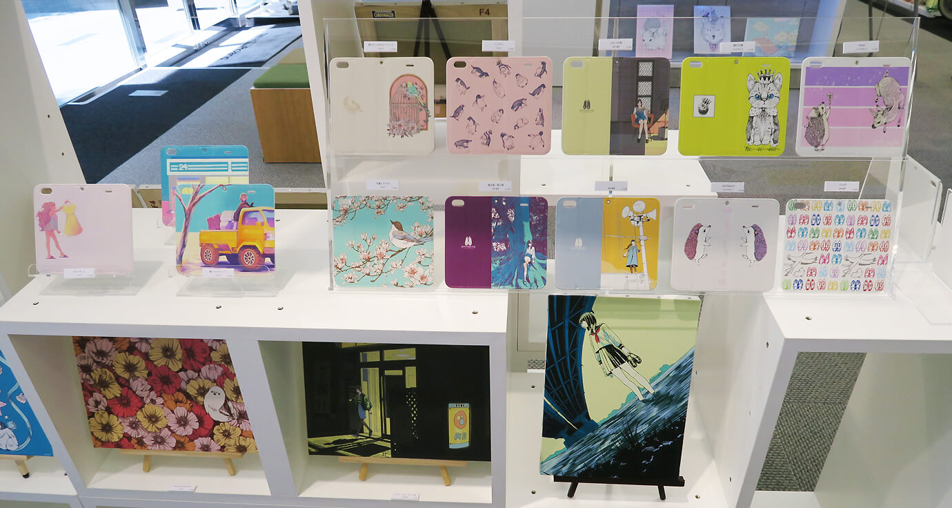 Original canvas prints and smartphone cases made by the 11 creators who contributed to the event.