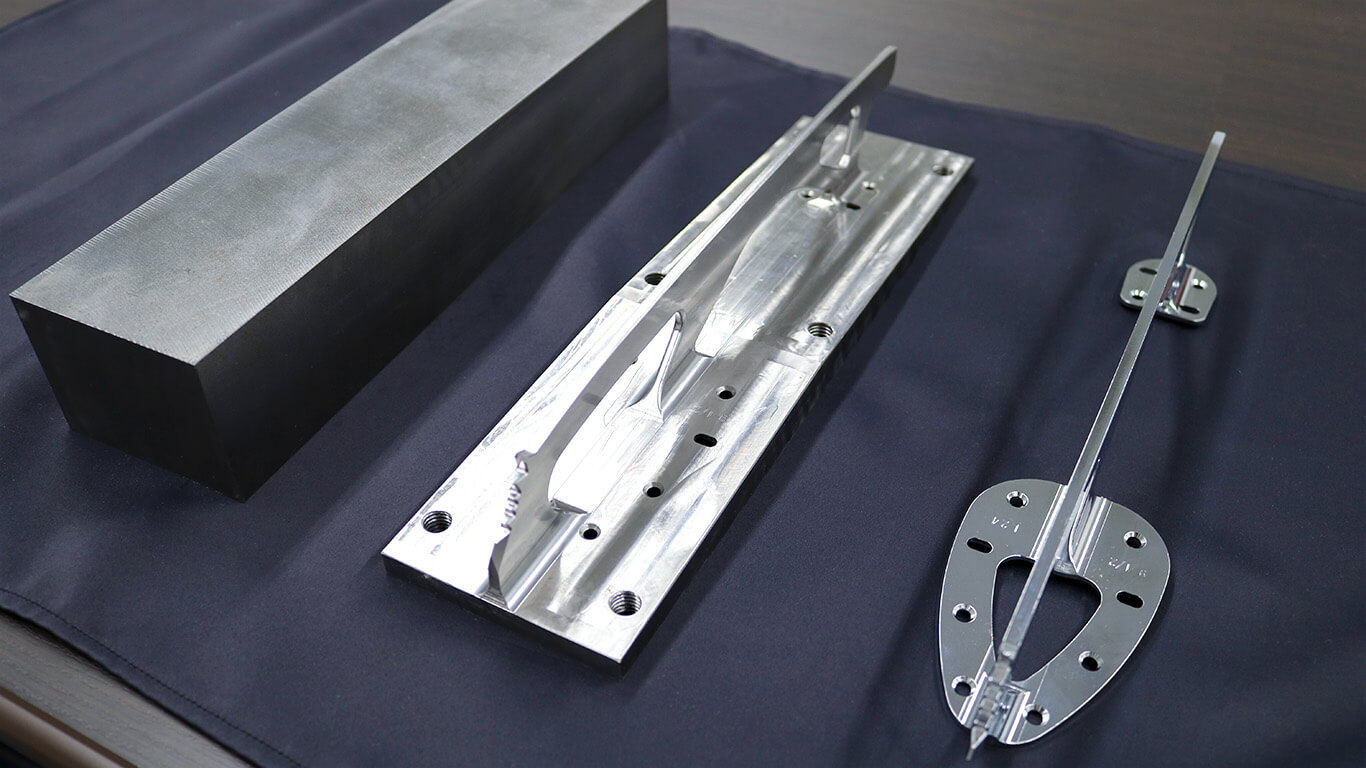 A steel block weighing more than 10kg (left) is carved out with a milling machine (center), to create the finished product (right) that weighs just 270g, or around 2% of the original block.