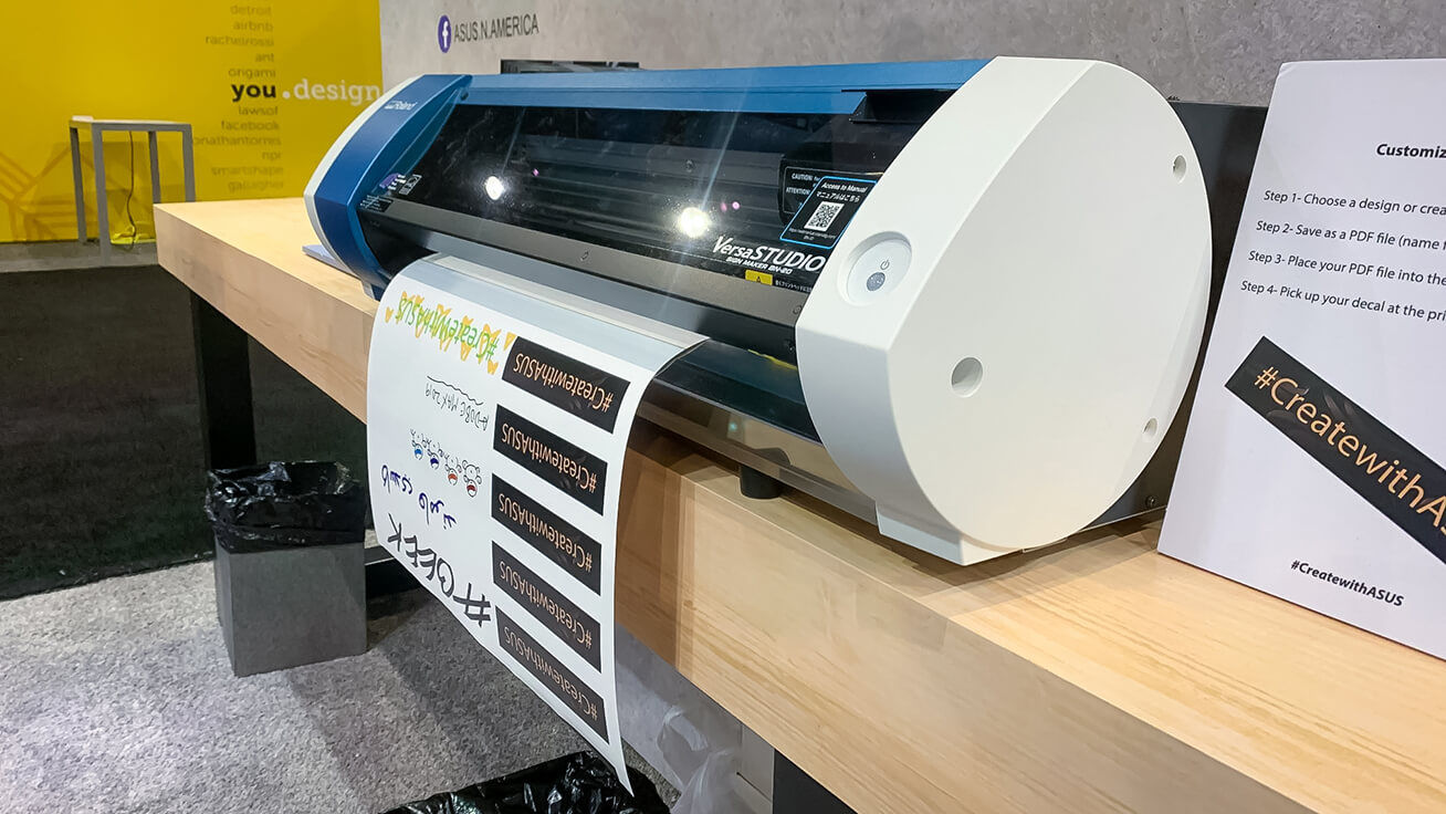 The VersaSTUDIO BN-20 printer/cutter printing laptop stickers for attendees in the ASUS booth.