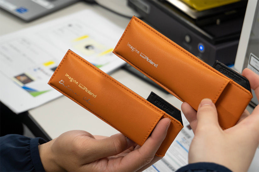 Using the laser decorators to put logos and names on a leather pen case