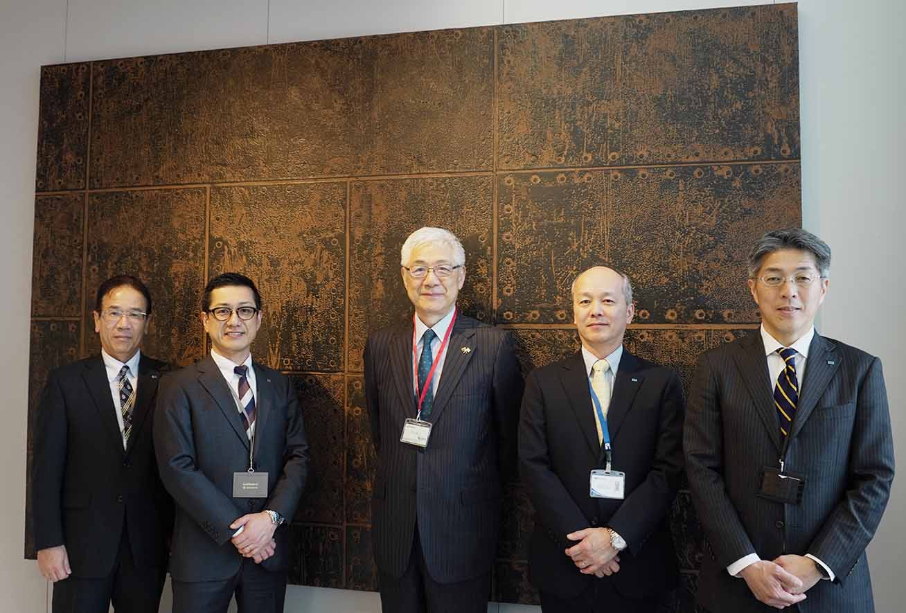 Commemorative photo in front of wall decoration by DIMENSE