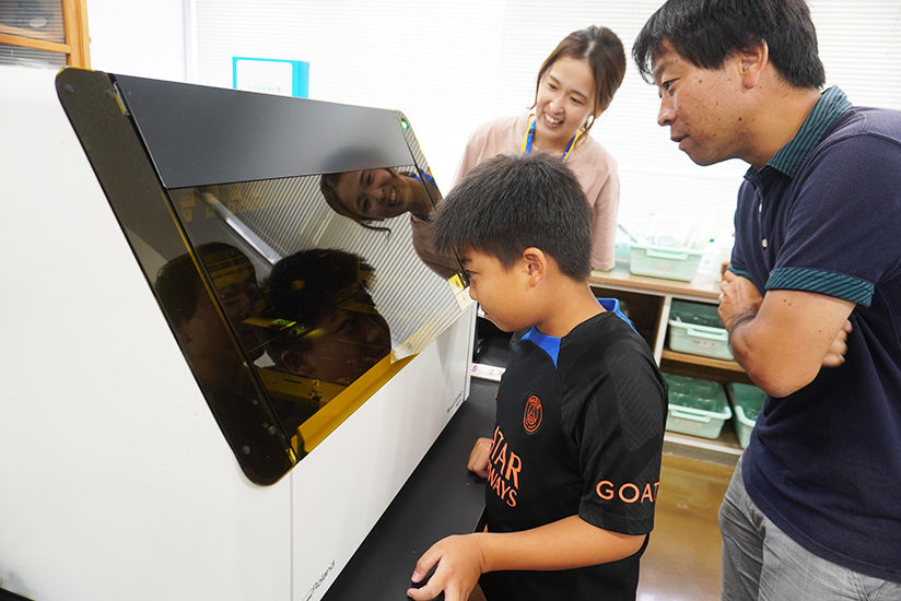 Parents and children watching the printing process