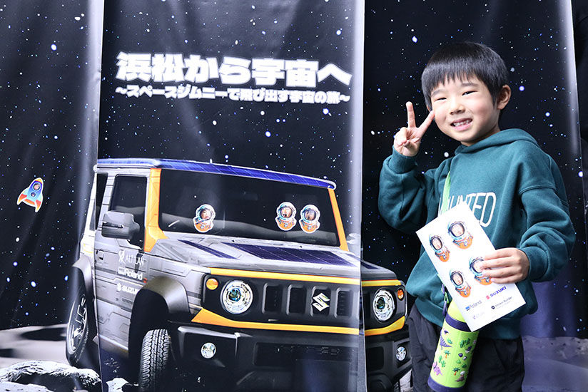 Commemorative photo in front of the event banner
