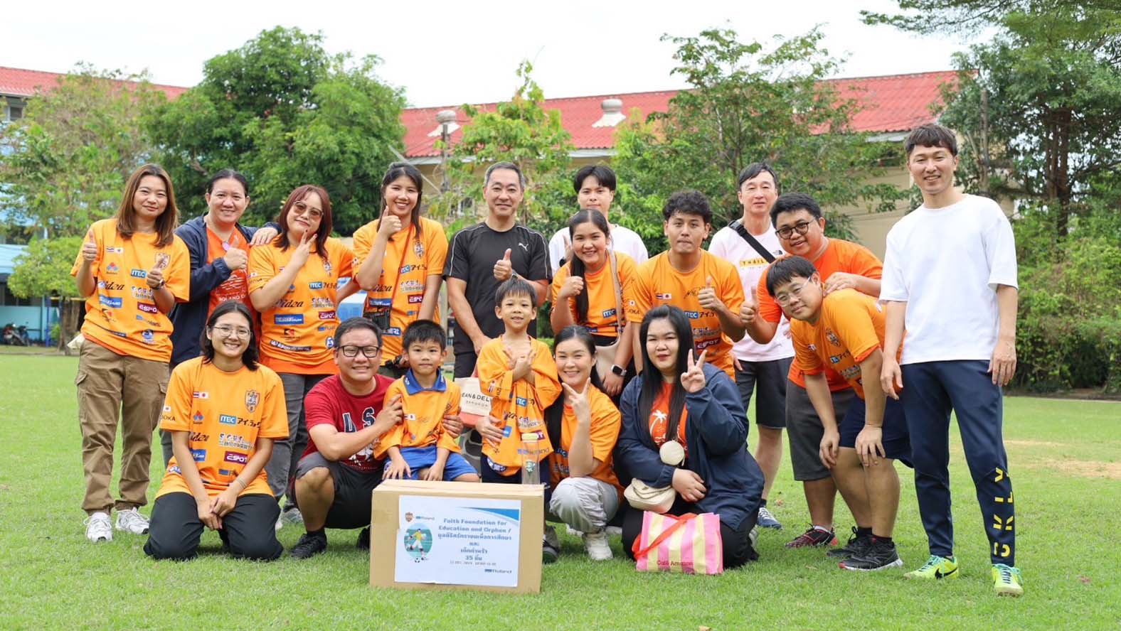 Group photo with Thai factory staff and their families