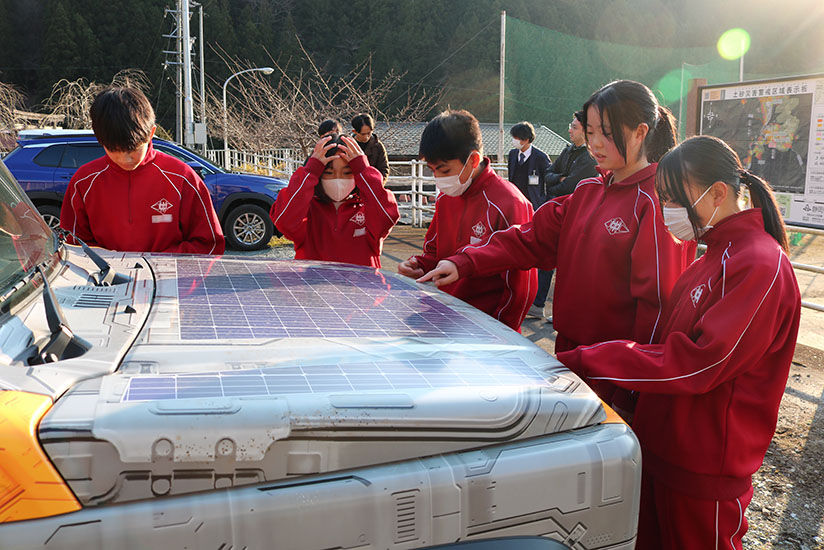 Students touching the car wrap