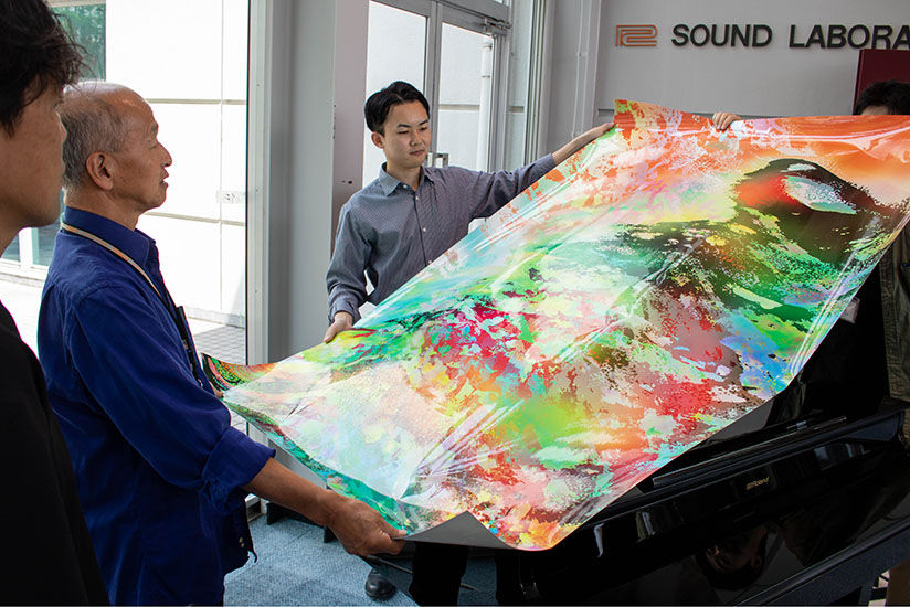 Reviewing the wrapping image with Roland staff