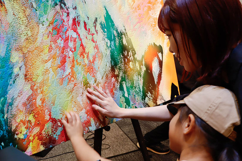 Touching the embossing to experience the artwork