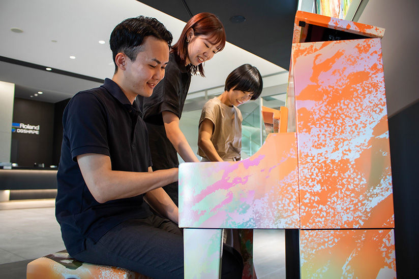 Visitors and employees freely playing the piano