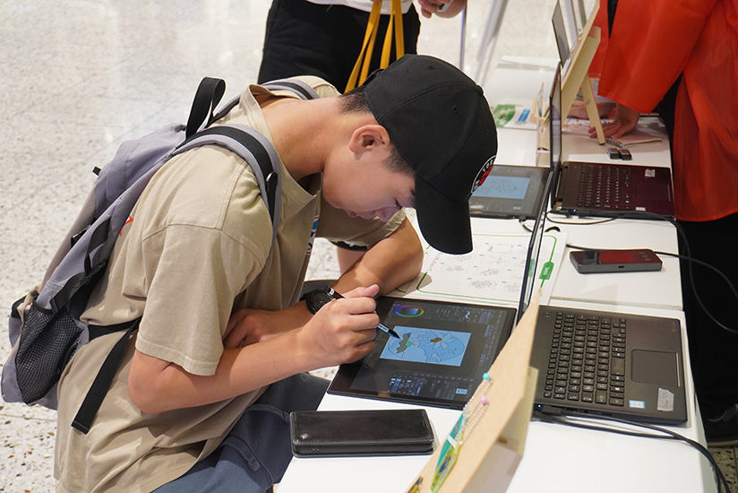 Participants painting in a coloring book