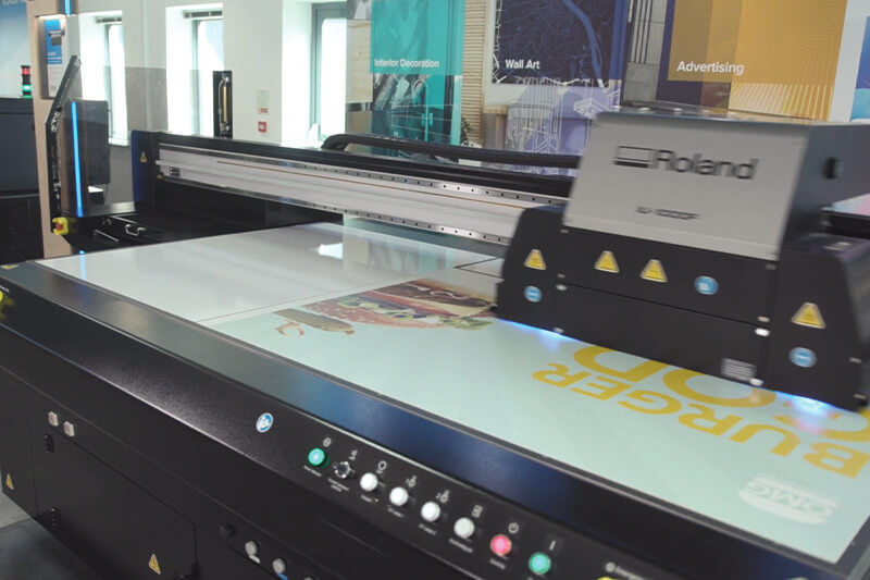 A high-output flatbed UV printer in action