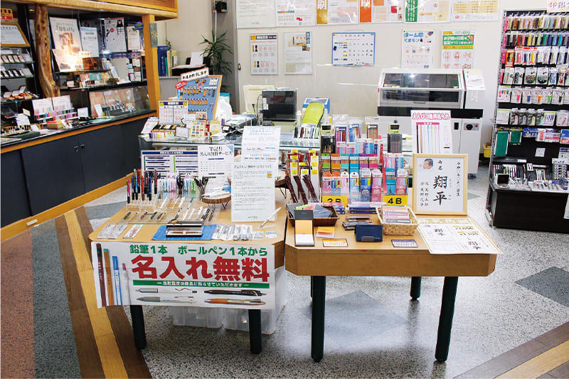 店舗入り口の右側にある名入れコーナー。手前には名入れできる文具を陳列。奥にはLEF2-200を設置。