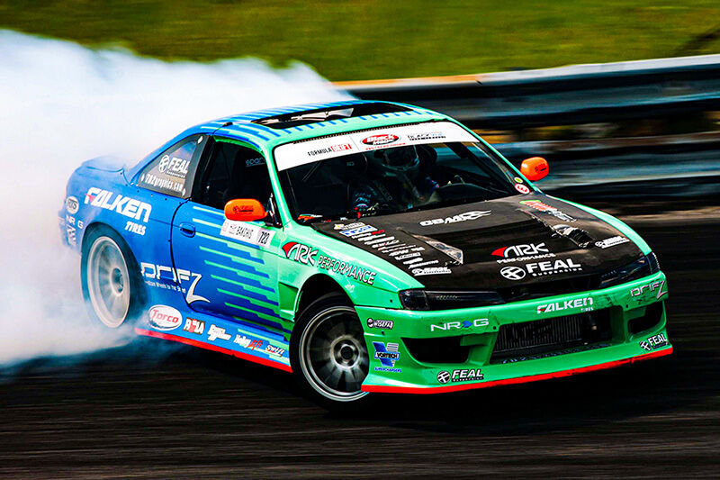 Race car with bright blue and green graphics printed on a Roland DG wide-format printer/cutter.