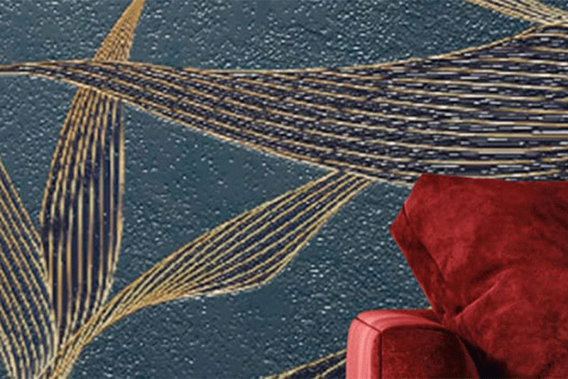 Teal and gold wall graphics with a red couch.